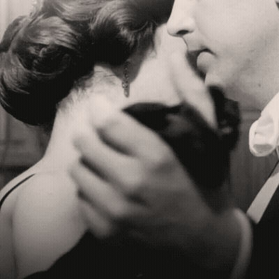 Man Kissing Woman's Neck Black And White GIF