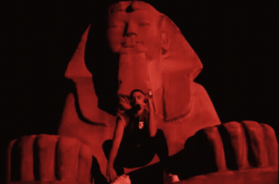 Man Kneeling Before Sphinx In Red Light GIF