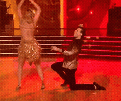 Man Kneeling Before Woman Dancing GIF