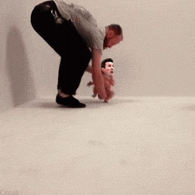 Man Kneeling Beside Baby With Man's Face Picture GIF