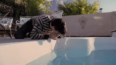 Man Kneeling Drinking Pool Water GIF