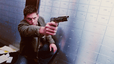 Man Kneeling Holding Gun GIF