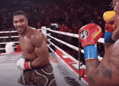 Man Kneeling In Boxing Ring Smiling GIF