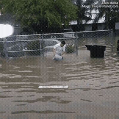 Man Kneeling In Flooded Area GIF