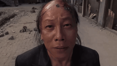 Man Kneeling In Front Of Building Number 10 GIF