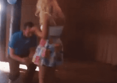 Man Kneeling In Front Of Dancing Woman GIF