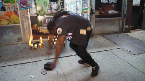 Man Kneeling In Front Of Fresh Coffee Sign GIF