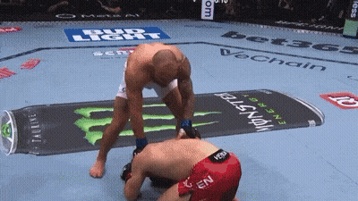 Man Kneeling In Front Of Monster Energy Drink Advertisement GIF