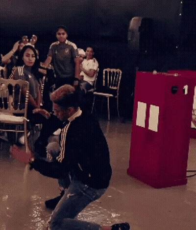 Man Kneeling In Front Of Red Box Number 1 GIF