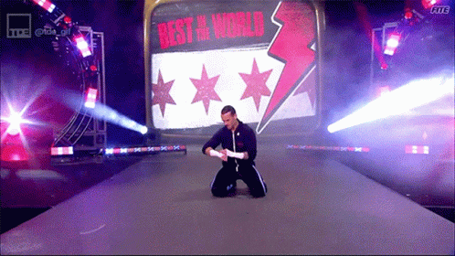 Man Kneeling In Front Of Sign Best In World GIF