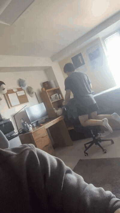 Man Kneeling In Room With Desk And Chair GIF