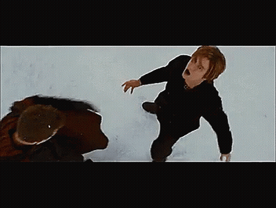 Man Kneeling In Snow While Another Rides Snowboard GIF