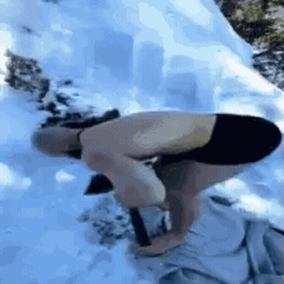 Man Kneeling In Snow With Shovel GIF