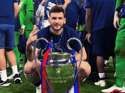 Man Kneeling Next To Champions League Trophy GIF