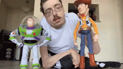 Man Kneeling Next To Toy Story Buzz Lightyear And Woody GIF