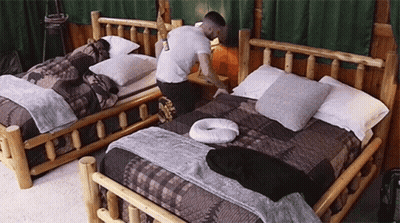 Man Kneeling On Bed In Bedroom GIF