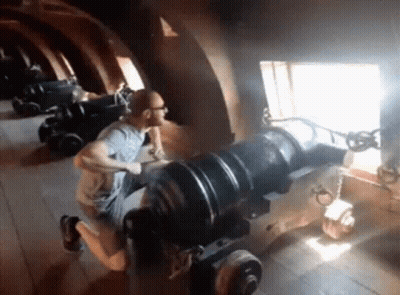 Man Kneeling On Cannon GIF