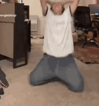 Man Kneeling On Floor With Arms Outstretched GIF