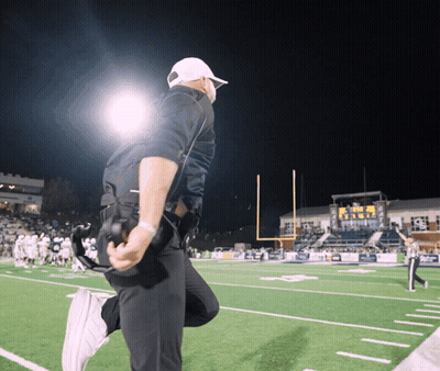 Man Kneeling On Football Field Saying Texas GIF