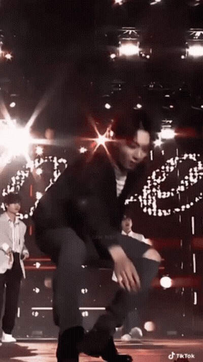 Man Kneeling On Stage In Front Of Crowd GIF