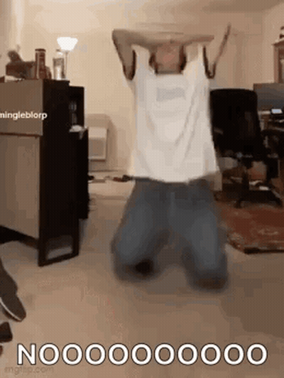 Man Kneeling With Arms Outstretched In Living Room GIF