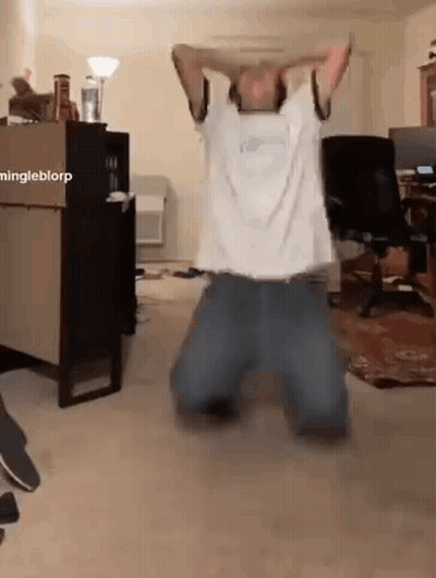 Man Kneeling With Arms Over Head GIF