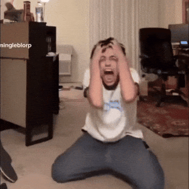 Man Kneeling With Hands On Head In Front Of Ningleblorp Box GIF