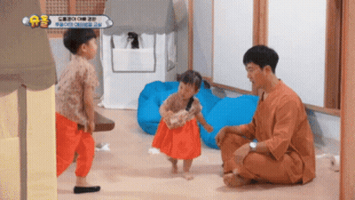 Man Kneeling With Two Little Girls And AE Sign GIF