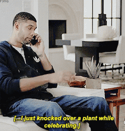 Man Knocking Over Plant While Celebrating GIF