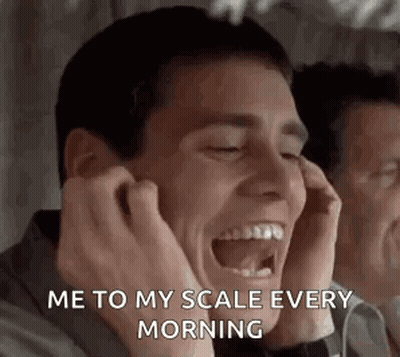 Man Laughing Covering Ears In Mirror GIF