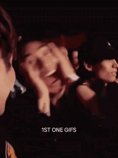 Man Laughing Hand On Face In Crowd GIF