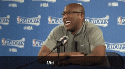Man Laughing In Front Of NBA Playoffs Sign GIF