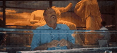 Man Laughing In Front Of Statue GIF