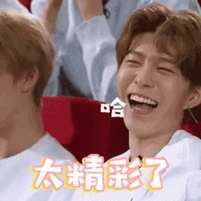 Man Laughing In Theater With Chinese Writing On Screen GIF