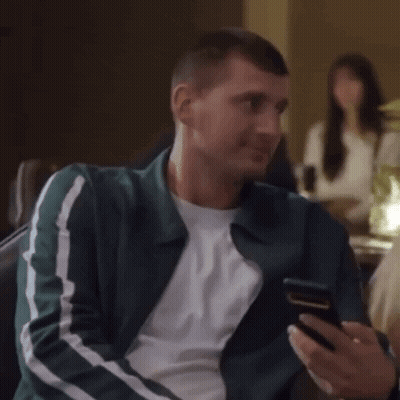 Man Laughing Looking At Phone GIF