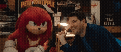 Man Laughing Next To Stuffed Animal With Pete Whipple Poster GIF