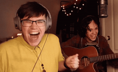 Man Laughing With Headphones And Guitar GIF