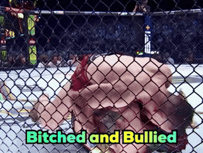 Man Laying Behind Chain Link Fence Saying Bitches And Bullied GIF