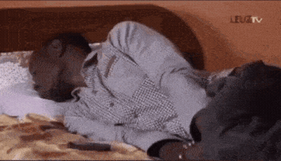 Man Laying Head On Another Man's Stomach GIF