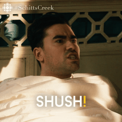 Man Laying In Bed Saying Shush GIF