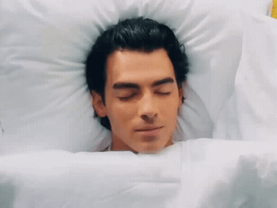 Man Laying In Bed With Eyes Closed GIF