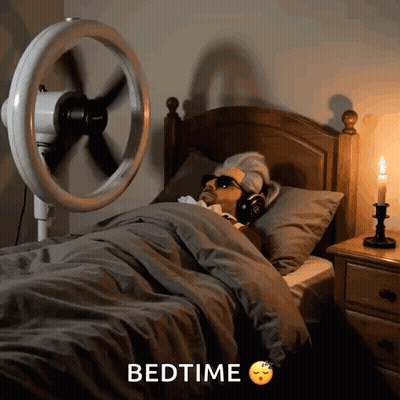 Man Laying In Bed With Fan Saying Bedtime GIF