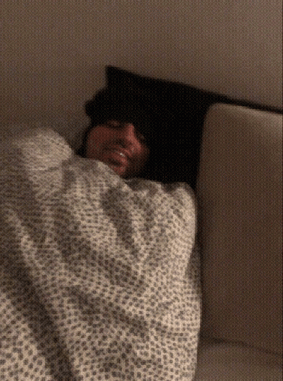 Man Laying In Bed With Leopard Print Blanket GIF