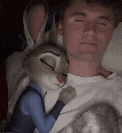 Man Laying In Bed With Stuffed Rabbit GIF