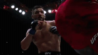 Man Laying In Boxing Ring With Crypto.com Sign GIF