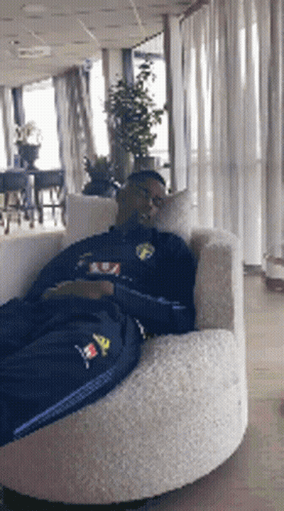 Man Laying In Chair With Adidas Shirt GIF