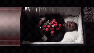 Man Laying In Coffin Holding Red Roses GIF