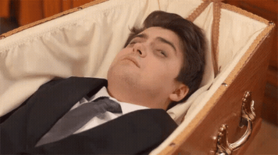 Man Laying In Coffin With Eyes Closed GIF