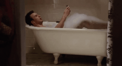 Man Laying In Foam Bathtub GIF