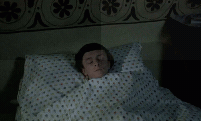 Man Laying In Polka Dot Bed GIF